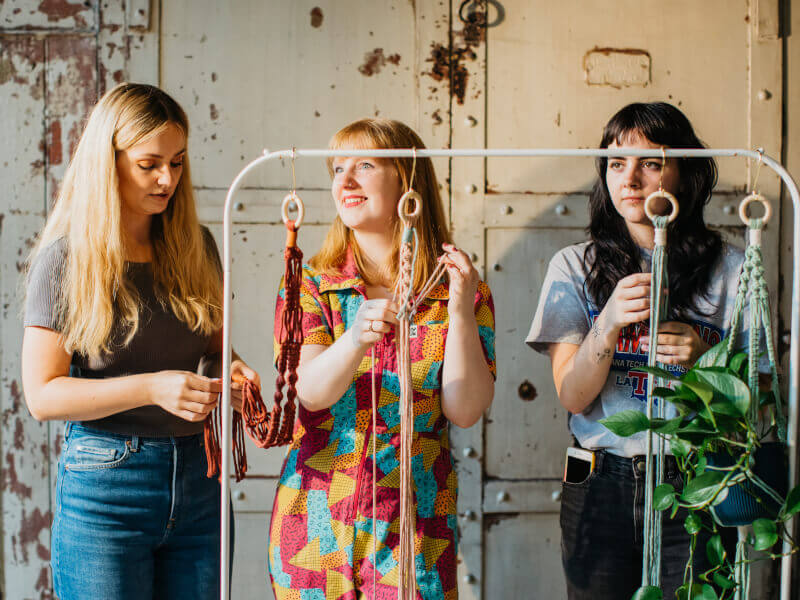 three women at a macrame class